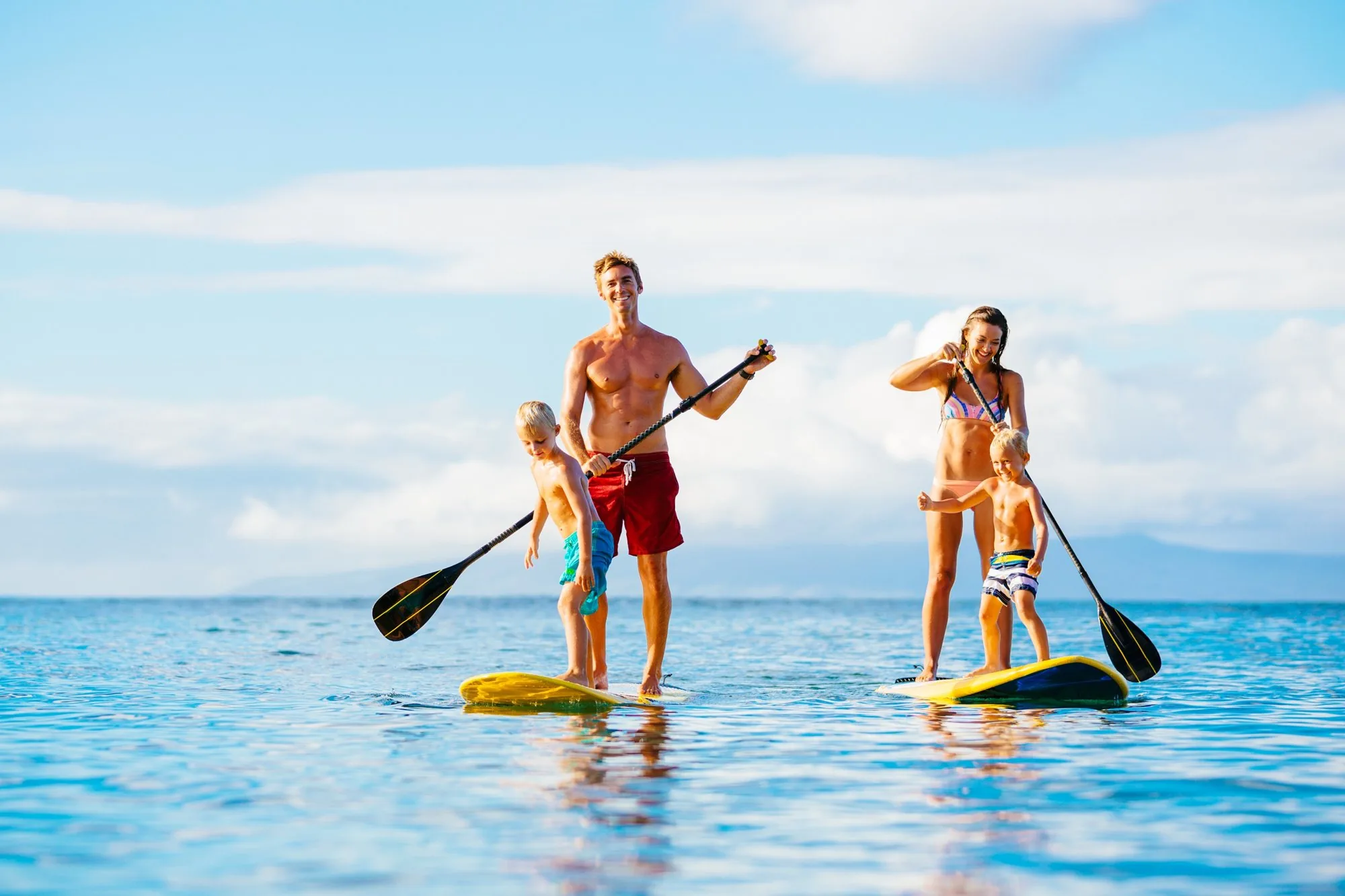 Paddle boarders on the turquoise water off Seven Mile Beach