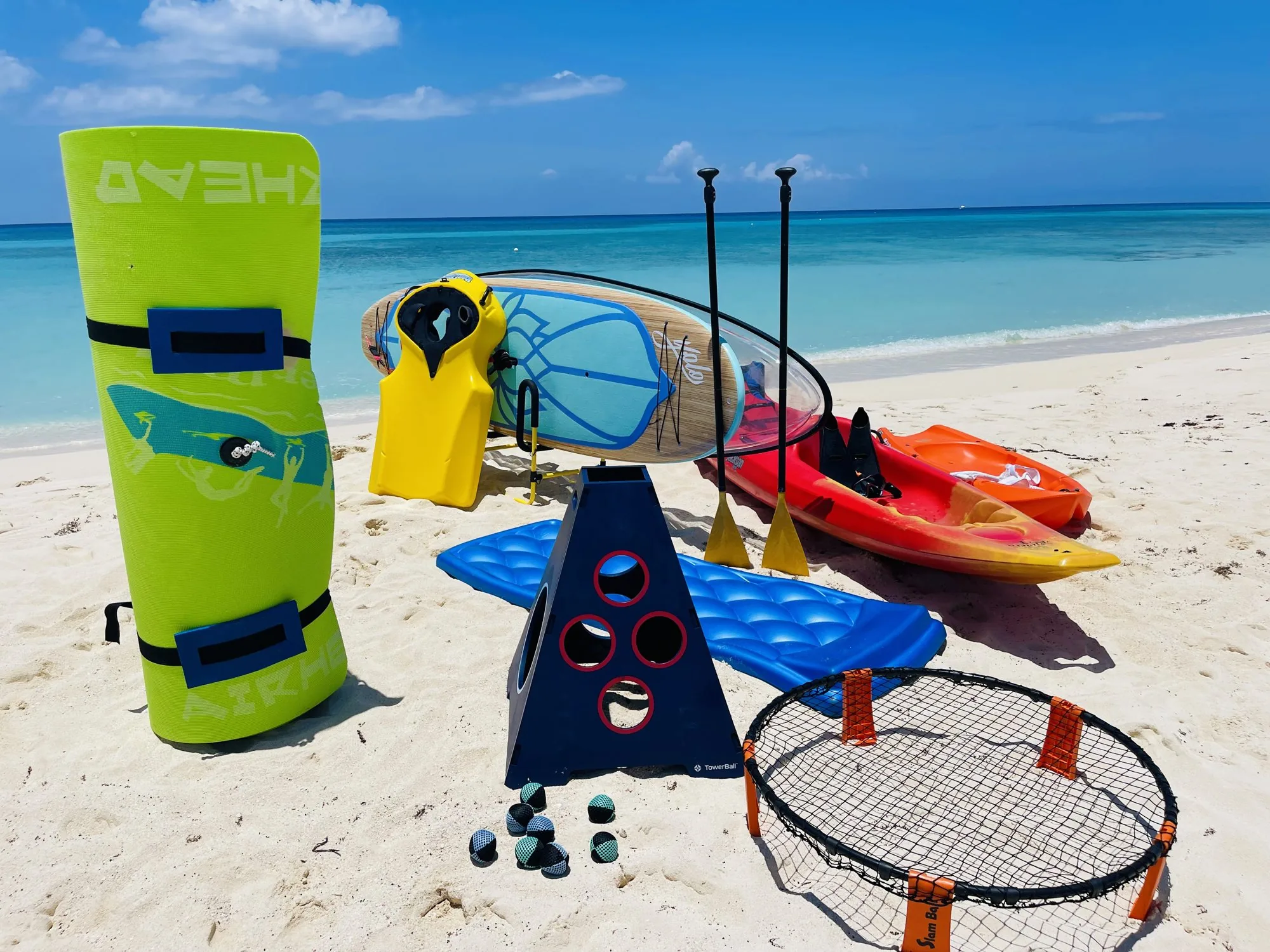 Floats, boards and beach games laid out on the sand